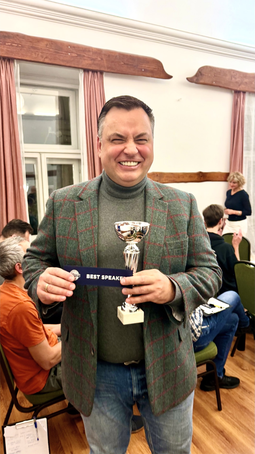 Mykola Latansky holding the Best Speaker award at Toastmasters in Budapest
